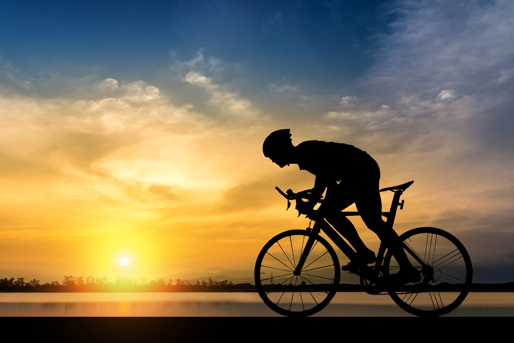 bicycle rider in front of a sunrise